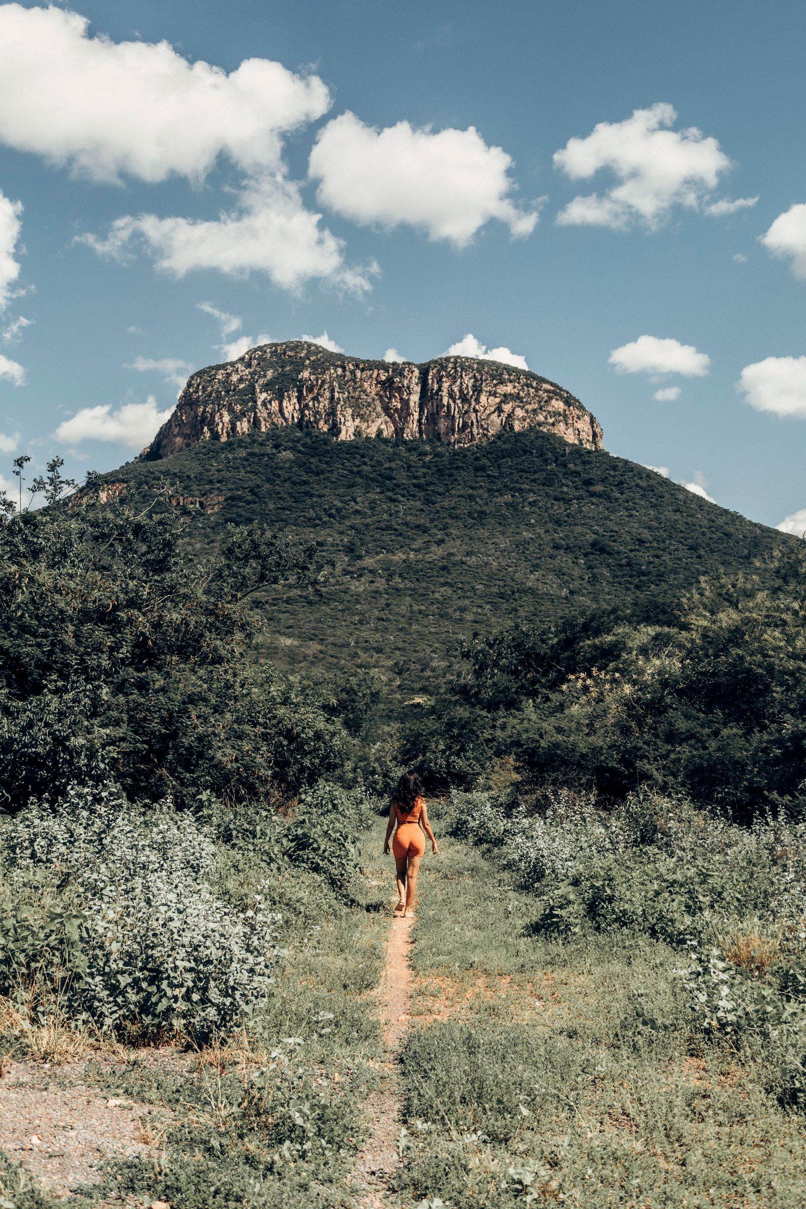 A hiker on a footpath below a bushveld koppie near Pretoria